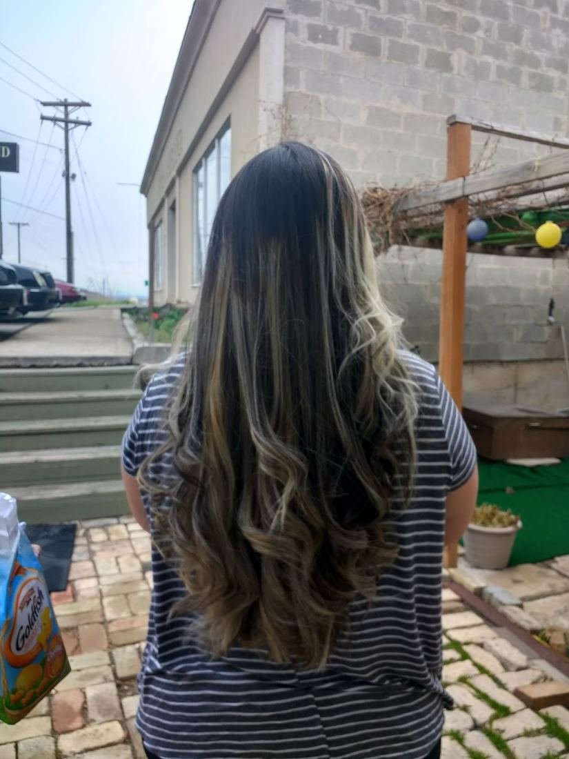 Long dark hair with balayage highlights styled at Blue Salon